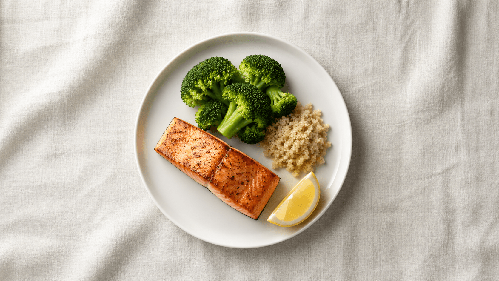 Small balanced plate: 25g protein portion of salmon with broccoli and quinoa